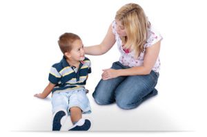 lady speaking to a young boy and a safeguarding issue