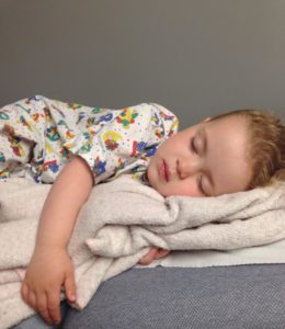 a child in A&E on a hospital bed
